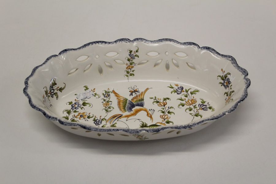 A French Quimper type Faience bread basket, polychrome decorated with phoenix and floral sprigs.