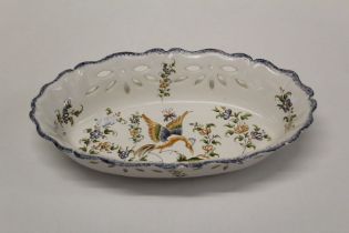 A French Quimper type Faience bread basket, polychrome decorated with phoenix and floral sprigs.