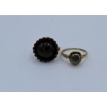 An early 19th century closed back blueish stone set ring with carved shank, along with a closed back