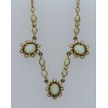 A "9ct" stamped Edwardian style opal necklace. Featuring three cluster panels of opals