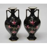 A pair of Edwardian twin handled vases of hexagonal form, each enamel and gilt decorated with pink