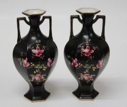 A pair of Edwardian twin handled vases of hexagonal form, each enamel and gilt decorated with pink