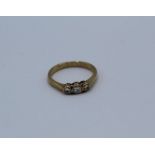 A 0.40 carat diamond 9ct yellow gold rub over set trilogy ring, boxed. Round brilliant cut