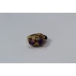A 9ct gold ring, set three cabochon amethyst, to a part textured shank, 8gms gross weight, size R