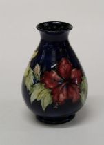 A 1950's Walter Moorcroft Hibiscus pattern vase of bellied ovoid form, decorated with crimson,