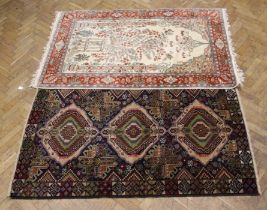 A Caucasian style hand knotted rug in dark tones, 195 x 121cm and a Persian style hand knotted