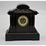 A Victorian ' black slate' mantle clock, the architectural case enclosing an eight day movement