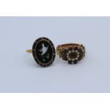 A pair of antique rings. A early 19th century garnet and seed pearl gold overlay ring with metal