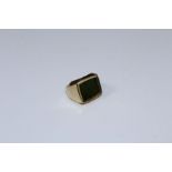 A 9ct gold ring, set with oblong jade panel, to a plain shank. 8gm gross weight, size J