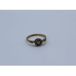 A diamond daisy ring, set with a central round brilliant cut stone, estimated 0.07 carats,