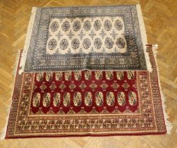 A hand knotted Turkoman style rug having two rows of seven guls, 158 x 126cm, another similar with