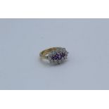 A 9ct yellow gold "boat style" amethyst and diamond ring. Estimated total weight of amethyst 0.58ct,