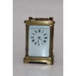 An early 20th century brass, five glass carriage clock with pillared case, enamel Roman dial. 14cm 9