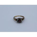 A pink stone and old mine cut diamond cluster ring in unmarked yellow metal, size Q, 3.7 grams
