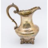 A Victorian silver baluster milk jug, shaped rim, C-scroll handle with acanthus thumbpiece, on