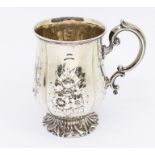 A Victorian silver baluster mug, embossed floral panel decoration, plain shaped cartouche, on flared