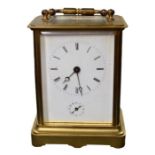 A French brass carriage clock with enamel dial, clear glass viewing panels, signed 'Aiguilles' to