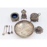 A collection of white metal Eastern items to include; a matching cruet set with embossed with