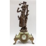 A large Victorian French mantel or novelty clock depicting a girl collecting apples under a tree.