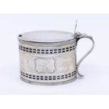 A George III silver oval mustard pot and cover, bright cut and pierced decoration, shaped