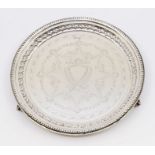 A late Victorian silver salver, beaded border, the centre engraved with vacant shield shaped