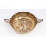 An Arts and Crafts style two handled silver quaich style bowl, the handles with stylised pierced