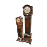 Two oak grandmother clocks, different sizes, one with loose cover and broken glass