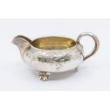 A Russian 84 Standard silver circular squat milk jug, on three shell feet, engraved decoration,