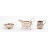 A collection of three silver jugs to include: 1. George III oval cream jug, hallmarked by probably