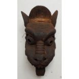 An Indian carved wood mask. H:45cm