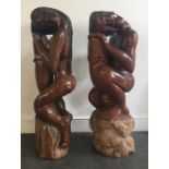 A pair of African carved wooden figures of a man and woman. H:109cm