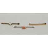 A 9ct white gold, pearl and pink coral bar brooch, set single round cabochon pink coral to centre