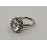 A 14ct. white gold and clear topaz dress ring, set single mixed round cut clear topaz to centre,