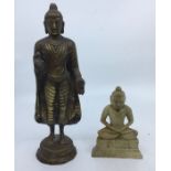 An Asian bronze figure of standing Buddha together with a carves soapstone seated buddha. (2) H:23.
