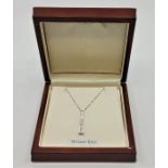 **WITHDRAWN**An 18ct. white gold and diamond pendant, of tapering form, set seven graduated round