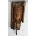 An Asian carved wood head of a deity. H:53cm