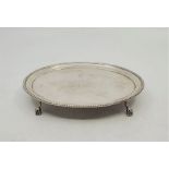 A George III silver teapot stand, by Hester Bateman, London 1784, with beaded rim, raised upon