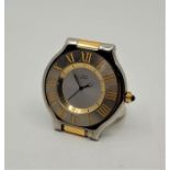 A Must de Cartier bi-colour quartz alarm table clock, with sapphire crown, signed width 5.5cm.