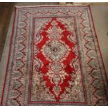 A contemporary Persian silk rug with central stylised foliate medallion, similar borders between