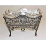 An Art Nouveau WMF table centrepiece cast with profile female heads and pierced tendrils on scroll