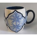 A Museum Trial Mug in the  " Snow flake  " pattern  by Moorcroft Decorated with a continuous band of