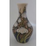 A Boxed design trial Moorcroft vase titled  " Diggory " it is decorated with white trailing flower
