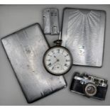 A Sterling silver pocket watch, key wound, along with two chrome plated cigarette cases, a novelty