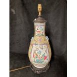 A 19th Century Cantonese enamel baluster vase, decorated with panels of exotic birds amongst