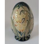 A boxed Moorcroft Spring Gifts Viola Egg  dated 2013 . 10.5cm high x 6.5cm in diameter . Condition ,