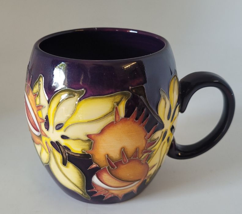 Moorcroft "Endagered species" mug decorated with conkers on a purple ground ,  9cm high