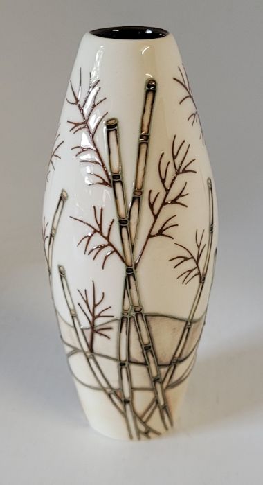 A boxed Moorcroft small vase, decorated in the Bamboo pattern , decorated with bamboo on a cream