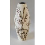 A boxed Moorcroft small vase, decorated in the Bamboo pattern , decorated with bamboo on a cream