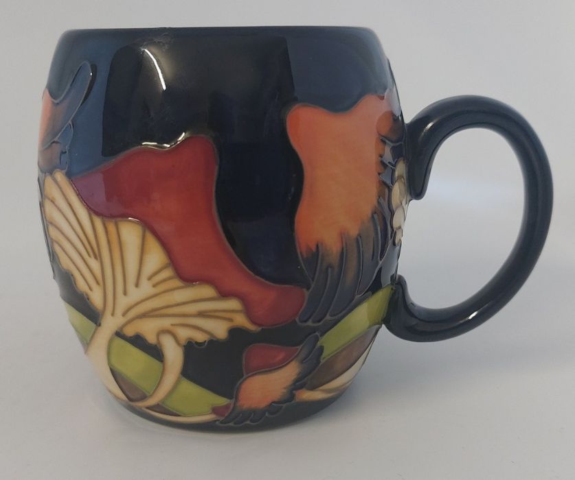 A Boxed Moorcroft mug, titled  " Parasol Dance "  it is decorated with flowers hanging over to cause