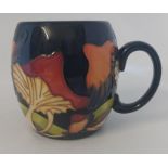 A Boxed Moorcroft mug, titled  " Parasol Dance "  it is decorated with flowers hanging over to cause